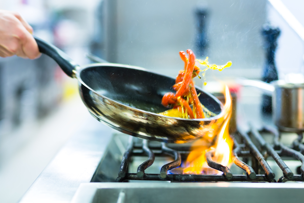 Chef,In,Restaurant,Kitchen,At,Stove,With,Pan,,Doing,Flambe Chef,In,Restaurant,Kitchen,At,Stove,With,Pan,,Doing,Flambe